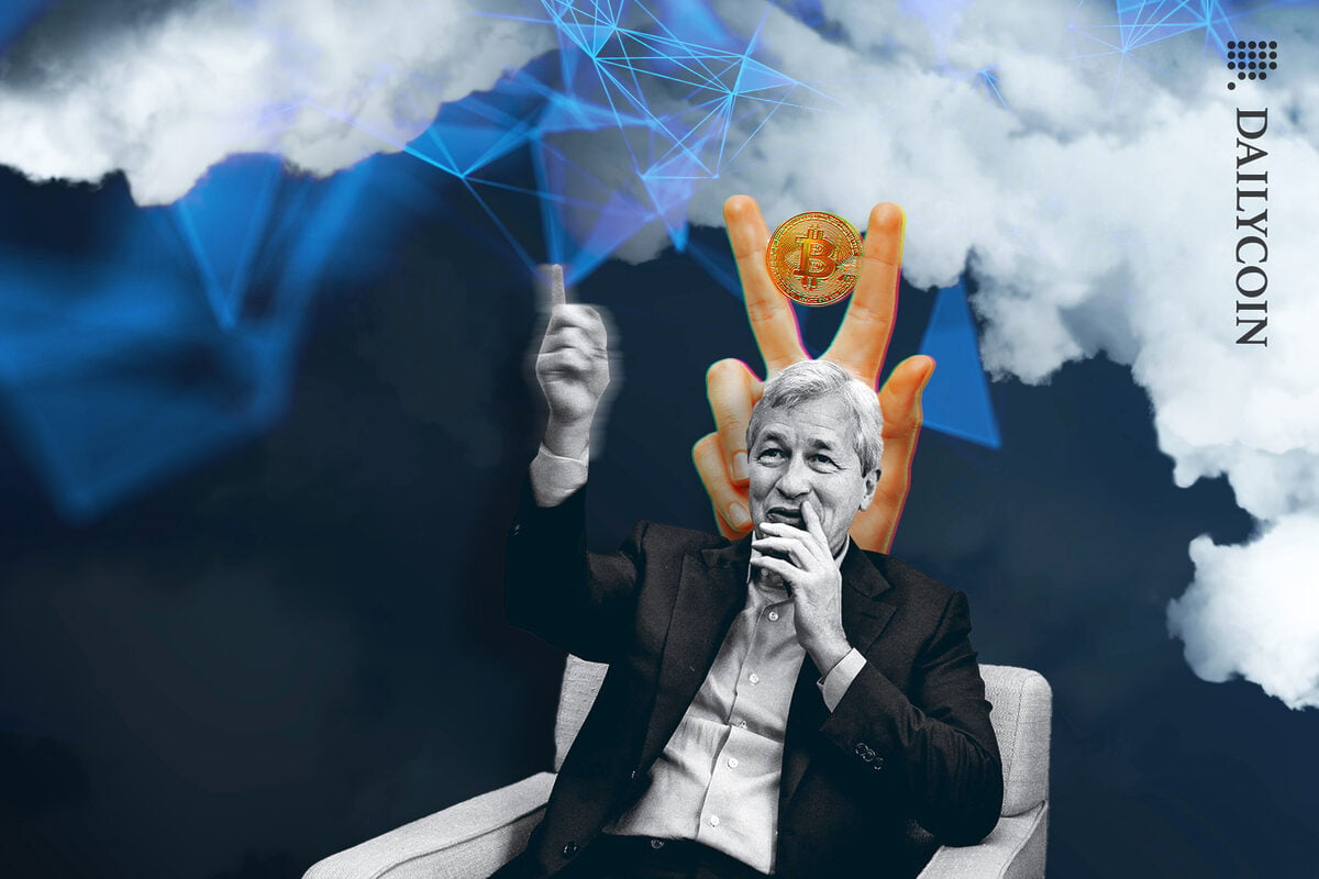 Jamie Dimon making fun of blockchain in the sky, and bitcoin victory fingers is photo bombing him.