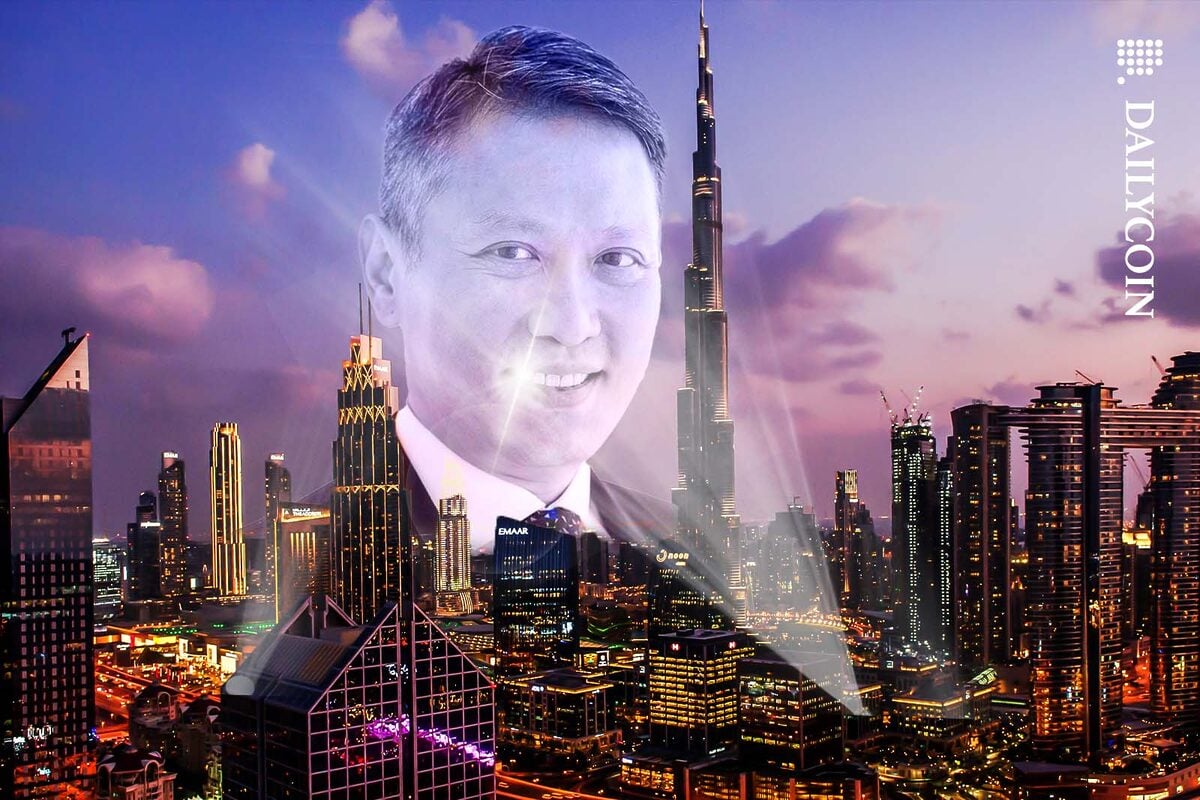 Richard Tang smiling above the skyline of Dubai.