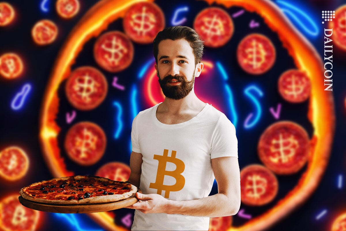 Guy with a pizza, wearing a bitcoin t shirt.