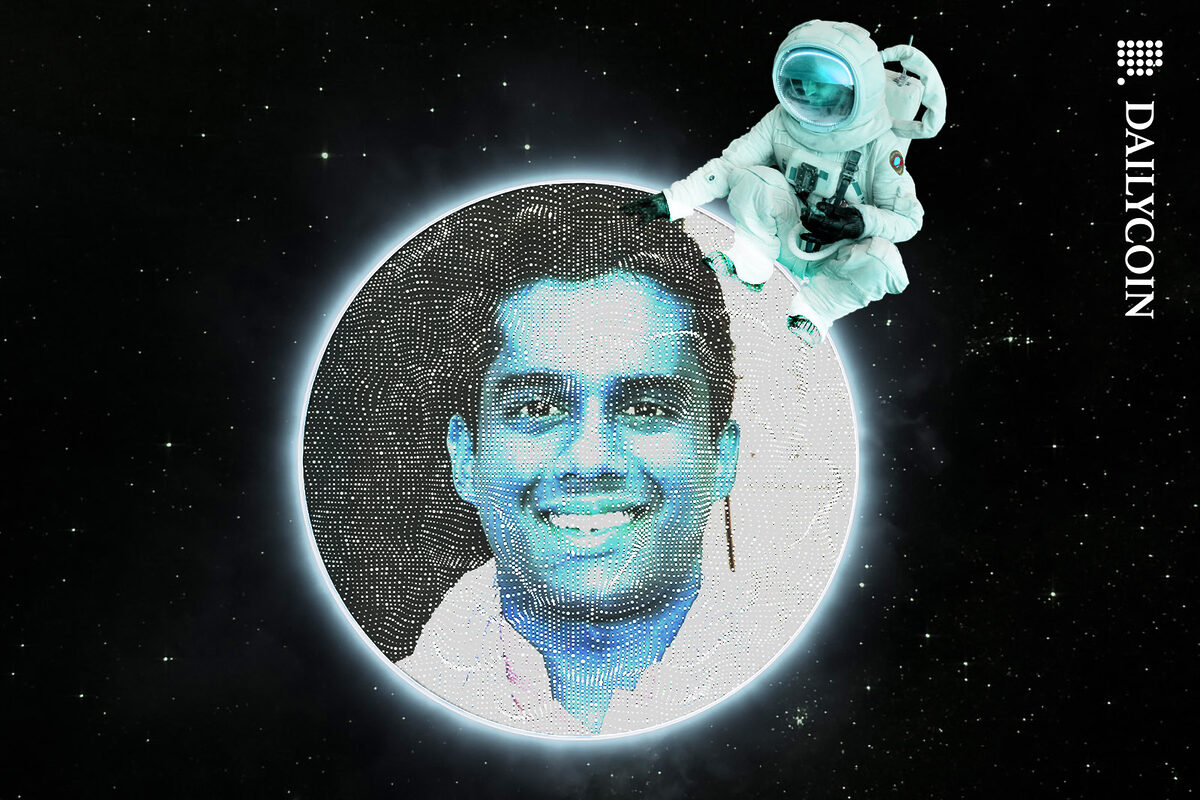 Vijay Chetty in and eclipse with an astronaut peting his head.