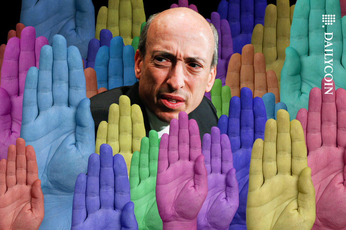 Gary Gansler looking disappopinted with the voting that is going on around him, visualised by many colourful hands.