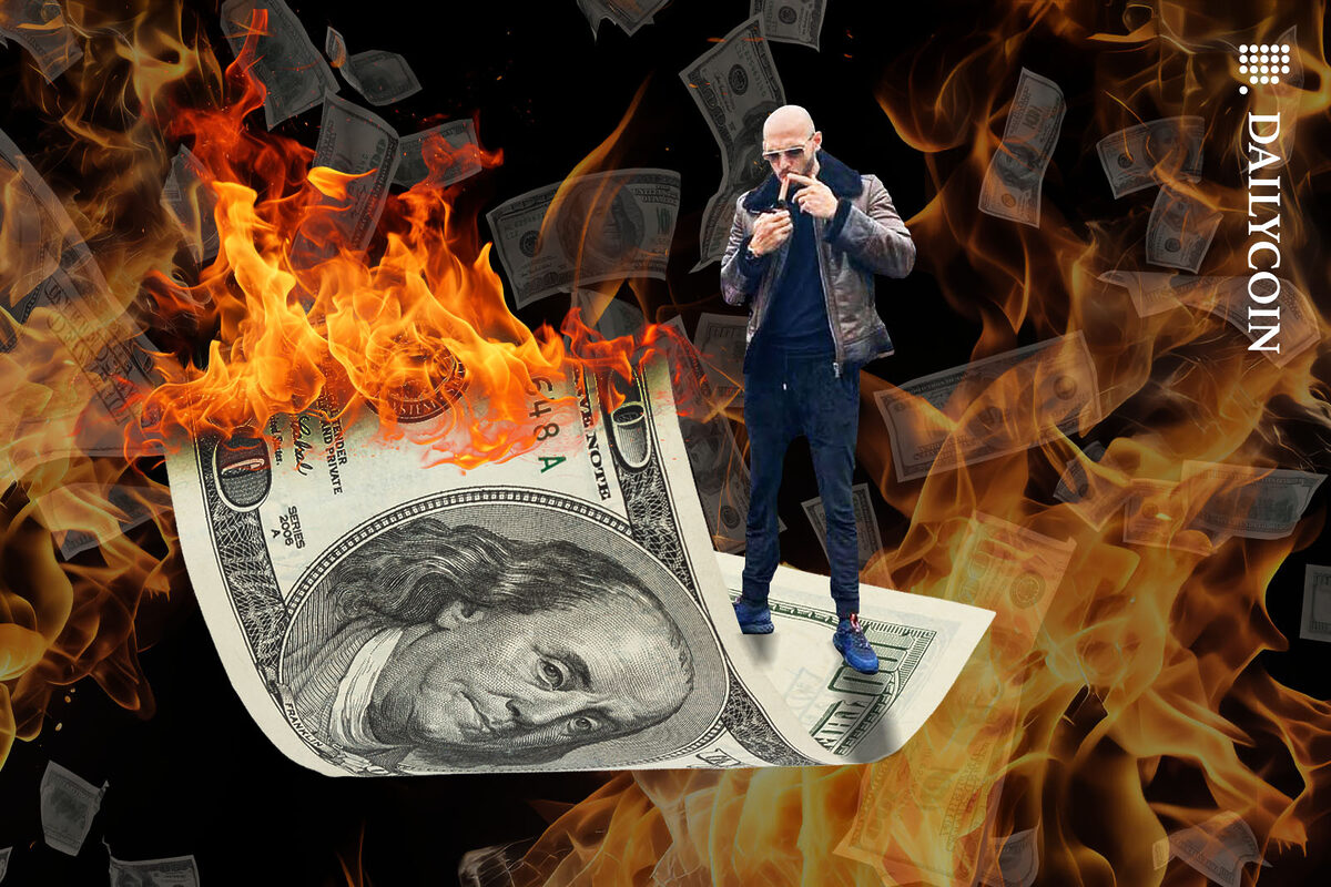 Adrew Tate standing on a burning 100 dollar bill as he is lighting up a cigar.