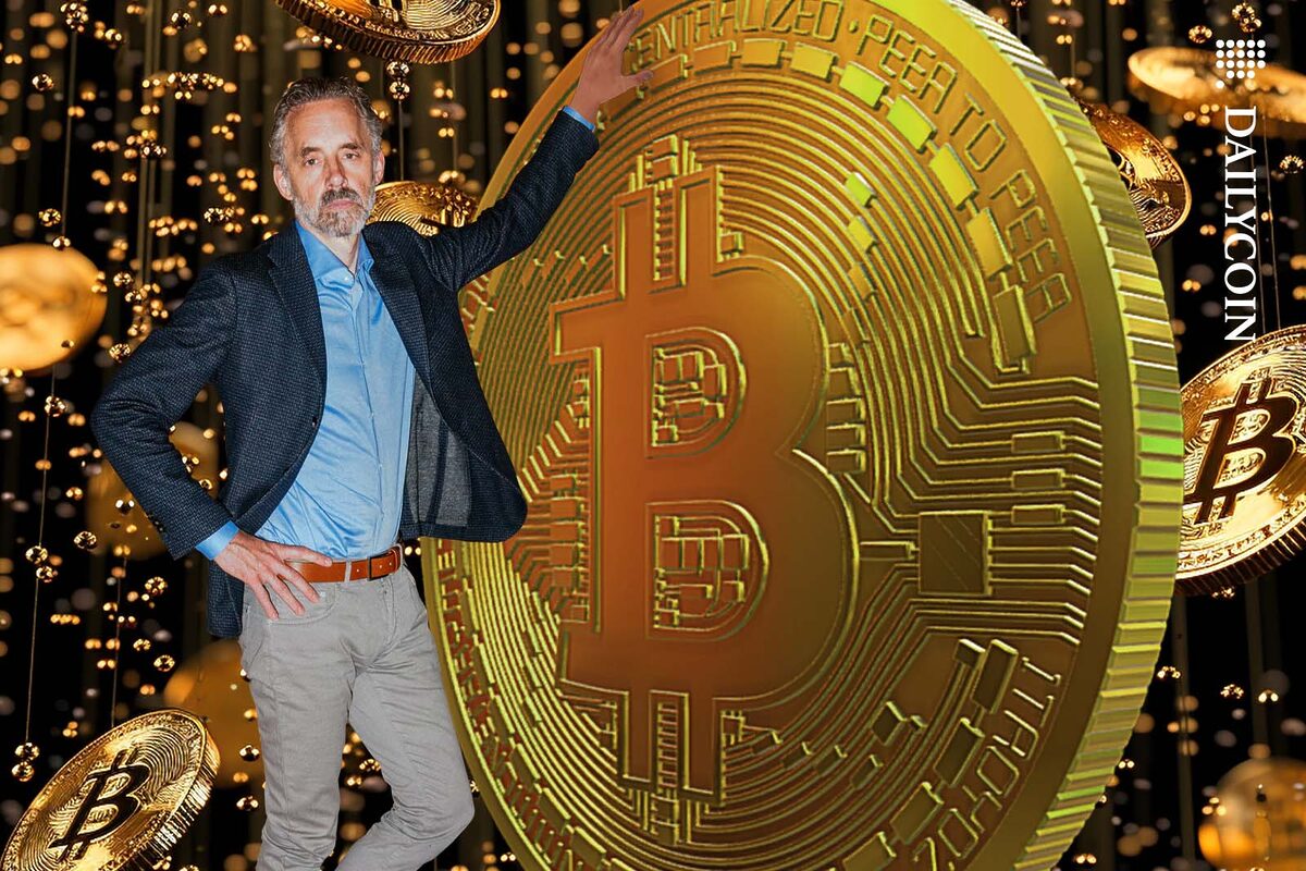Dr Jordan Peterson posing with a gigantic Bitcoin.