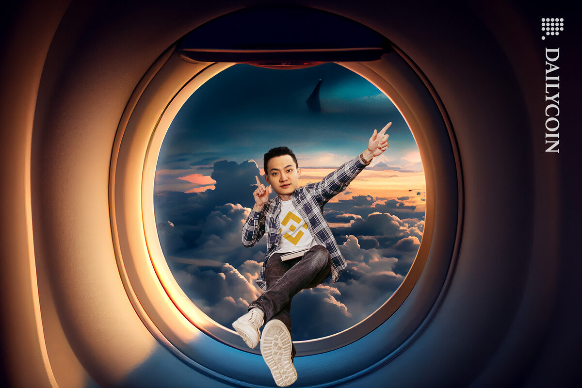 Justin Sun with his feet up on a airplane window, wearing a a Binance t-shirt pointing to the right direction.