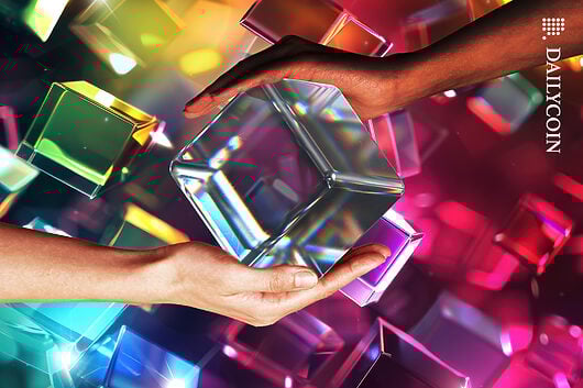 Hands holding together a digital cube with lots of digital cubes around in the background.