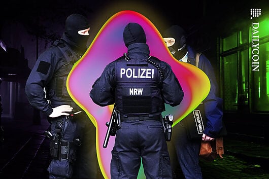 German police officers surrounding an unidentified colourful object.