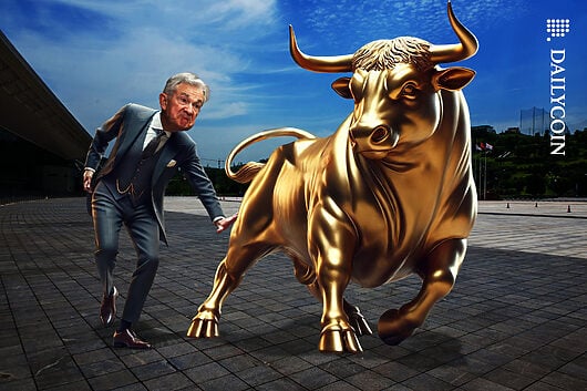 Jerome Powell smacking a golden bull on the bottom.
