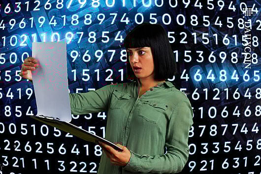 Woman is reading a white paper and is surprised, code is covering up hidden text.