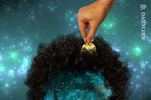 A hand taking a money bag out of Sam Bankman's hair.